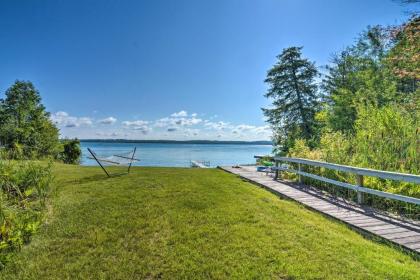 Torch Lake Home with 116 feet of Blue Water Access!